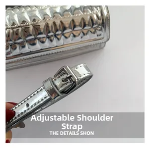 Close-up of adjustable silver mirror handbag strap with metallic buckles and precision stitching