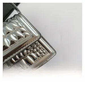 Close-up of silver mirror-finish quilted handbag showing premium fabric and stitching