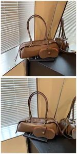 Detail of dark brown leather baguette bag with matching charm on a vanity table