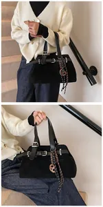 Close-up of matte black tote bag with buckle details and decorative knot pendant