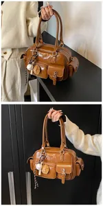 Detail view of brown PU bowling bag with multi-pockets and baseball glove charm