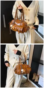 Detail view of brown retro bowling bag with multiple pockets and baseball charm