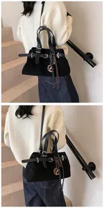 Detail of black frosted suede tote bag featuring adjustable leather straps and silver buckle