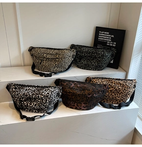Selection of leopard print waist bags in multiple colors displayed on a marble platform