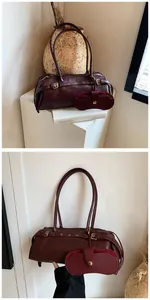 Detail of burgundy baguette bag with textured leather and a matching small pouch