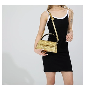 Detail of gold croc-effect handbag with metallic mirror finish and top handle on a model