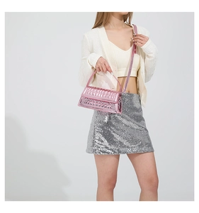 Detail of pink metallic textured handbag with checkered pattern and adjustable strap