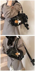 Detail of glossy black bowling bag with utility pockets and baseball theme charm