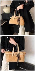 Detail of camel suede tote bag with leather strap, buckle, and decorative silk scarf