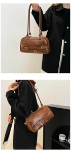 Detail view of brown retro PU leather shoulder bag with decorative buckles and bow knot