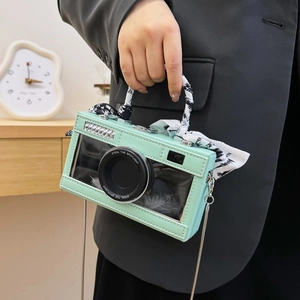 Mint green camera-shaped crossbody bag with transparent window and feather detail