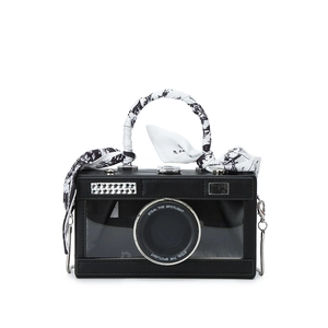 Chic camera-shaped crossbody bag with transparent lens detail and silk-wrapped handle