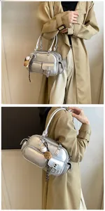 Detail of silver metallic PU bowling bag with multi-pockets and baseball heart charms