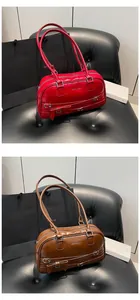Detail of red and brown vintage PU leather underarm bags with bow and silver buckle straps