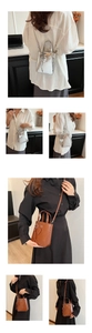 Multiple views of a small square crossbody bag with heart charm and COIH ION text logo