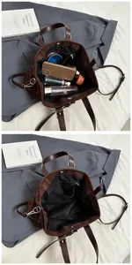 Internal view of large brown suede tote bag showing zipper pocket and spacious storage