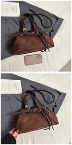 Close-up of brown suede tote bag with belt buckle detail and decorative rope charms
