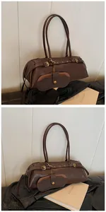 Detailed close-up of retro brown cylindrical handbag with decorative pouch and gold rivets