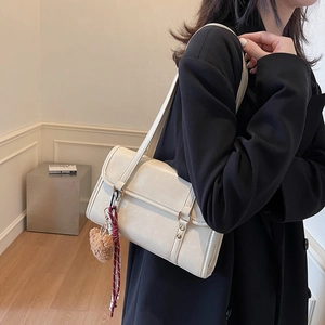 Retro cream faux leather crossbody bag with dual straps and plush heart charm accessory