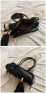 Detail view of black faux leather baguette bag with zip closure and striped lining texture