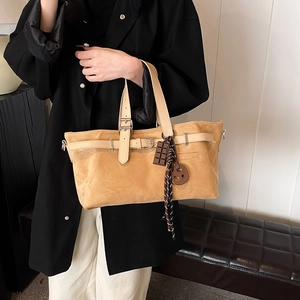 Matte suede tote bag with decorative leather straps and vintage metallic buckle