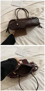 Dark brown baguette bag size comparison with phone showing spacious interior and texture