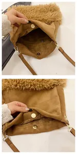Detail of the brown suede bucket bag featuring faux shearling trim and magnetic metal clasp