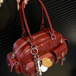 Dark red patent leather bowling bag with multi-pocket design and baseball charms