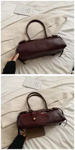 Detailed capacity view of a deep red baguette bag with side pocket and long strap