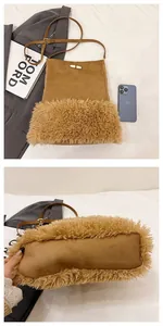 Detail of suede bucket bag with faux fur trim and toggle closure on white bedding
