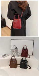 Detail view of mini crossbody bags in four colors with glossy oil leather and heart charm