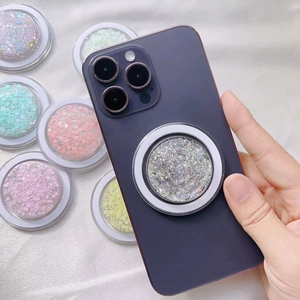 Glitter MagSafe folding phone socket stand for iPhone 16 on a purple smartphone