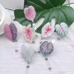 Retractable acrylic badge reels featuring tropical caladium leaf patterns for work cards