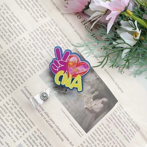 Macro shot of CNA badge reel with watercolor tie-dye heart and rotating back clip