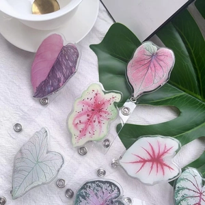Acrylic leaf-shaped retractable badge holders with monstera and caladium designs