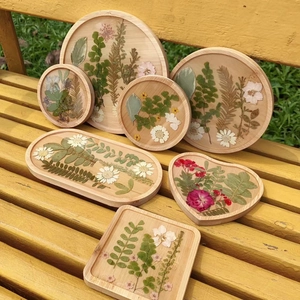 Close-up of dried flowers embedded in assorted resin wood coasters on a bench