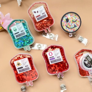 Detail of retractable glitter liquid badge reels with star-shaped sequins and medical theme