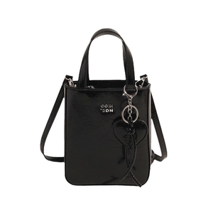 Glossy black mini crossbody bag with metal logo and heart charm on white background