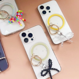 Detail of MagSafe phone ring holders with beaded bow charms in various colors