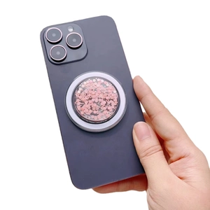Glitter pink MagSafe magnetic phone socket mount for iPhone 16 on a dark smartphone