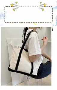 Detail of canvas tote bag with branded shoulder straps and black trim decoration