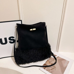 Black bucket bag featuring suede texture with faux fur trim and toggle horn closure