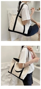 Detail of minimalist canvas tote bag showing dual black handles and large interior capacity