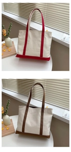 Detail of color-blocked canvas tote bags showing reinforced handles and textured fabric