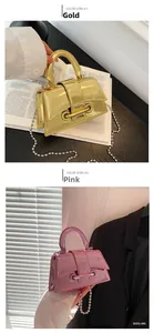 Detail of mini laser gloss handbags in gold and pink with metallic ball chain straps