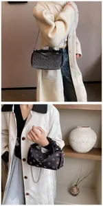 Close-up of elegant black rhinestone handbag with chain strap and ruched handle detail