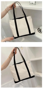 Detail of a large canvas tote bag with black wide straps and ivory fabric finish