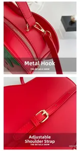 Detail of strawberry crossbody bag featuring golden hardware hook and adjustable strap