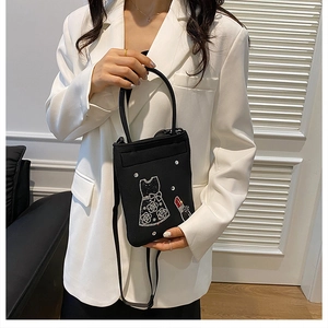 Chic black nylon crossbody bag featuring rhinestone dress and lipstick embroidery detail
