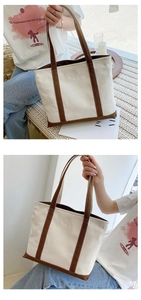 Detail of canvas tote bag with brown leather trim and sturdy reinforced handles